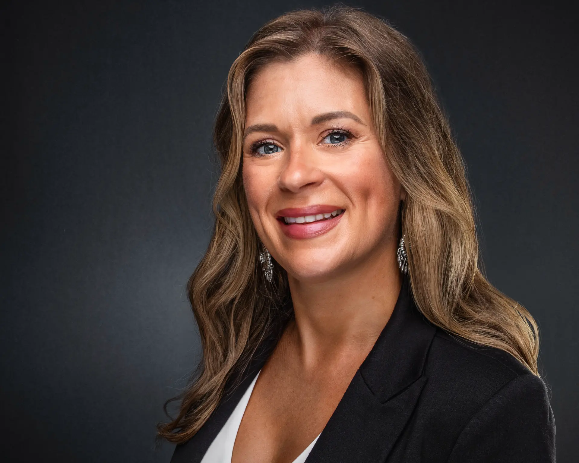 Studio headshot of a professional woman in a black blazer